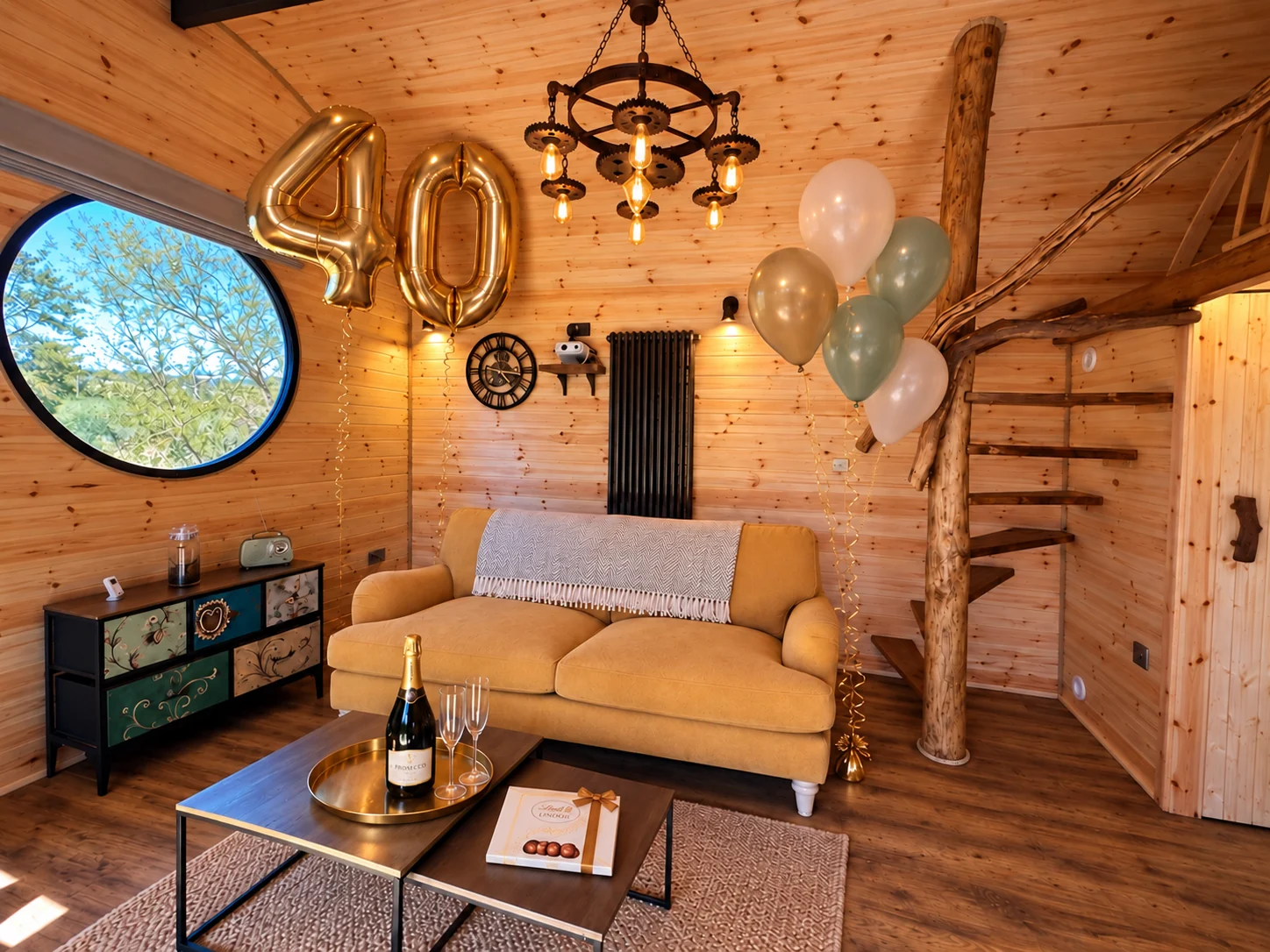 Illustrative Scranton Lodge 40th birthday celebration with gold number balloons, soft-coloured helium balloons, Prosecco, glasses and chocolates